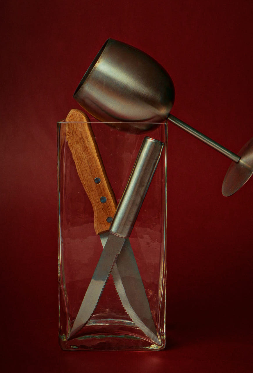 Assemblage abstrait de plusieurs ustensiles de cuisine : un verre dans un pot en verre. 